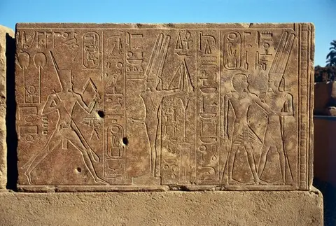 Queen Hatshepsut dancing before a representation of Min